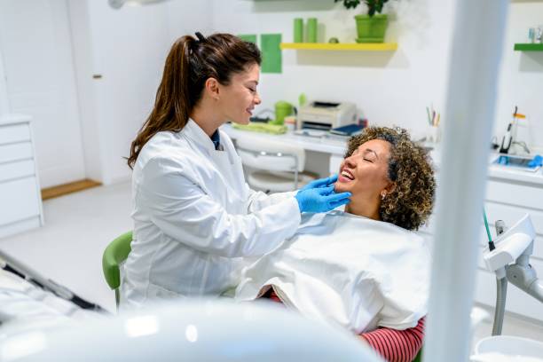 istock Mature woman having teeth examining at dentist 1459122147