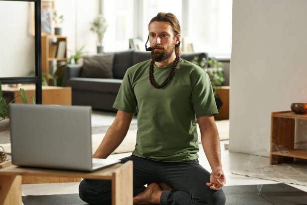 istock Yoga instructor teaching yoga online n latop 1459123030