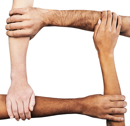 Multiracial group of hands and arms of men and women clasping each other, signifying unity, solidarity, cooperation and teamwork.