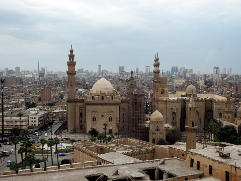 Cairo, Egypt, January 7 2023: Sultan Hassan and Al Rifa'i Mosques in old Cairo city Citadel square, very famous Islamic mosques in Egypt and very close to each other, selective focus and foggy view, selective focus