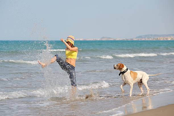istock girl with her dog on the beach 145912675