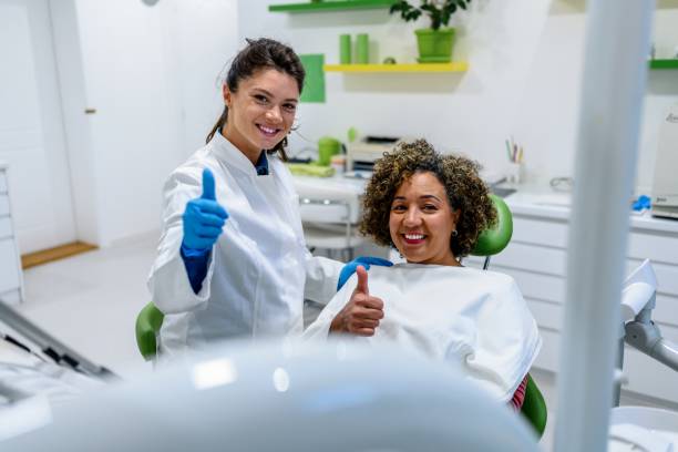 Dentist and patient pose in the dentist's office