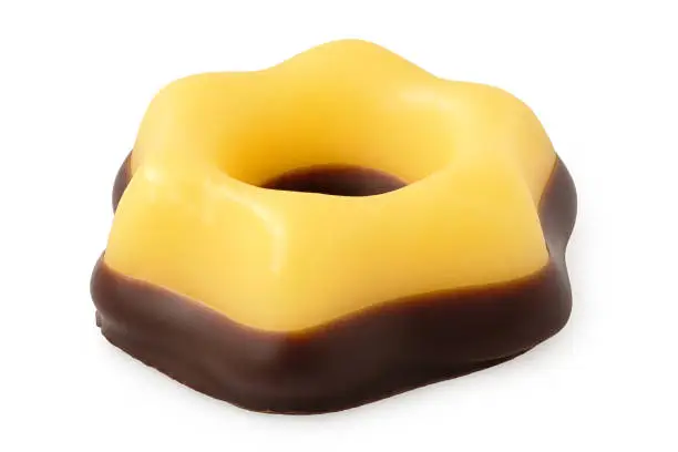 Yellow christmas fondant sweet dipped in chocolate isolated on white.