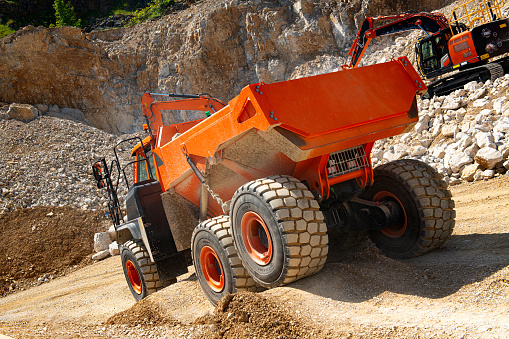 A dumper truck on a quarry in summertime