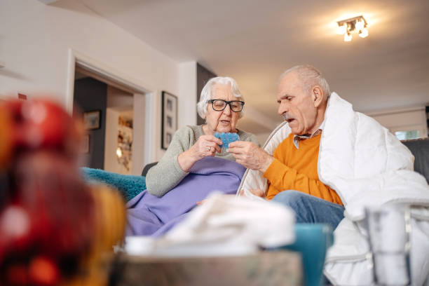 istock Old couple having flu at home 1459131575