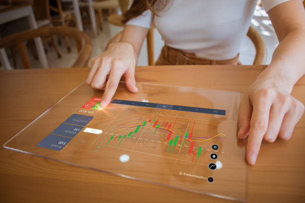 businesswoman using transparent futuristic tablet technology planning, strategy, stock market. working in cafe. technical price graph & indicator, red and green candlestick chart, stock trading screen - green report business bar graph imagens e fotografias de stock