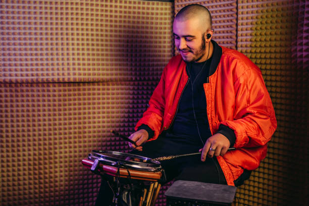 Drummer playing drums, different percussive musical instruments on a black background. High quality photo