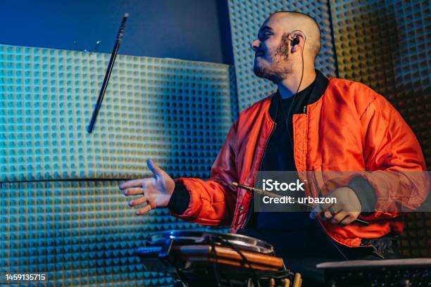 Young Man Playing Electronic Portable Drums In The Studio Stock Photo - Download Image Now