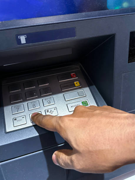 istock Full frame image of unrecognisable person pressing button with index finger on ATM keypad, entering cashpoint PIN number, cash machine, focus on foreground 1459136121