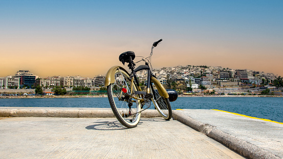 Vintage style bicycle standing on Pier of marina Zeas, opposite Kastella in Piraeus, Greece
