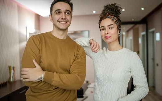 Happy couple woman and man caucasian husband and wife or girlfriend and boyfriend standing at home happy smile in their apartment real people copy space