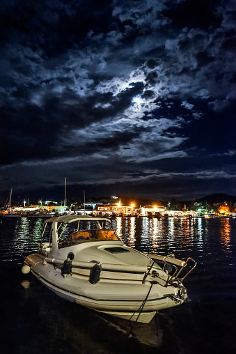 view of Porto Rafti by night under dramatic sky and moon .Greece