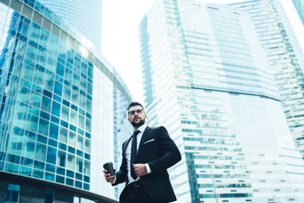 istock Male office employee having break and drinking coffee outdoors at downtown 1459138975