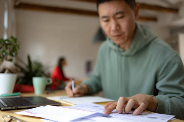 istock Close up of analyzing financial bills at home. 1459139308