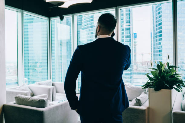 istock Respectable businessman phoning in modern office 1459139385