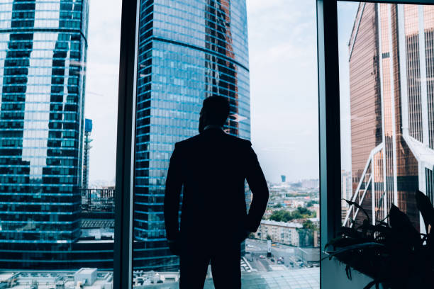 istock Confident male manager standing at window in office 1459139445