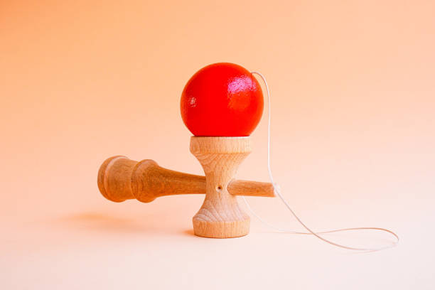 Kendama, Japanese traditional cup and ball toy Traditional Japanese toy consisting of a cross-shaped sword and a ball with a hole in it kendama traditional japanese toy stock pictures, royalty-free photos & images