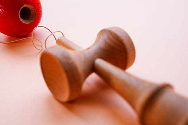 Kendama, Japanese traditional cup and ball toy Traditional Japanese toy consisting of a cross-shaped sword and a ball with a hole in it kendama traditional japanese toy stock pictures, royalty-free photos & images