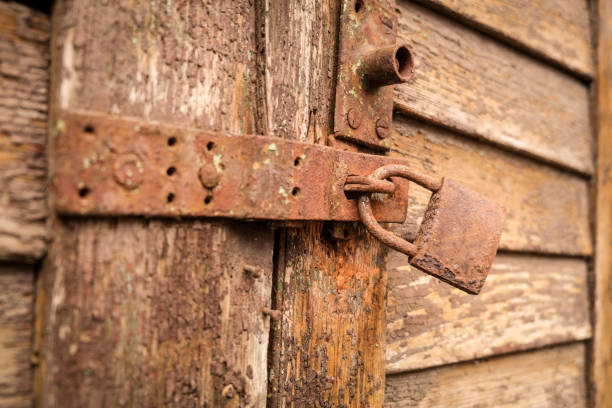 istock Extremely rusty lock on an old and weathered wooden door 1459140759