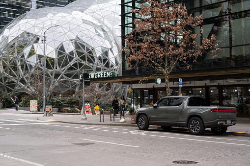 Seattle, USA – Jan 4th, 2023: An electric Rivian truck parked at the Amazon Spheres campus late in the day.