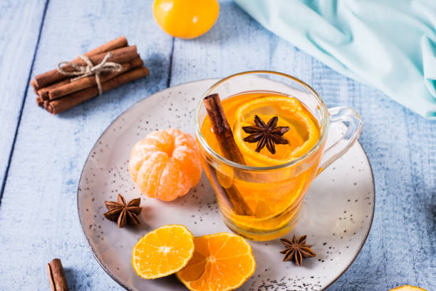 istock Fresh tangerine tea with cinnamon in a cup on the table. Vitamin drink. 1459141569