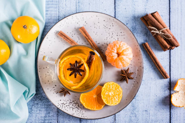 istock Mandarin tea with cinnamon and anise in a cup on the table. Antioxidant diet. Top view 1459141584