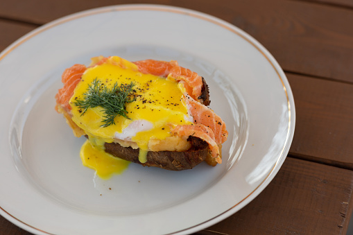 Baked potatoes with fish and egg benedict