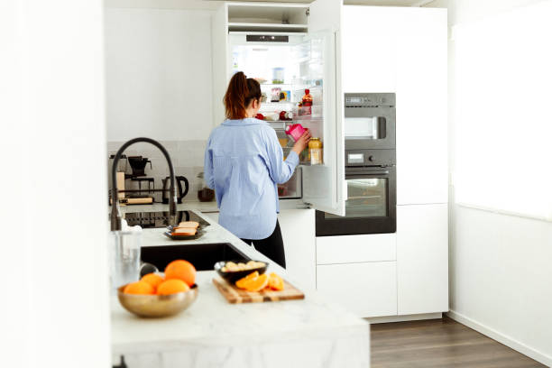 istock Woman picking up some milk from the fridge 1459145061