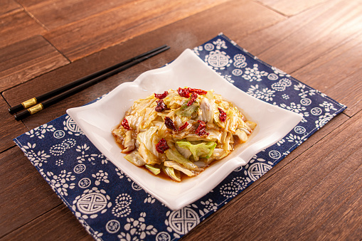 Spicy chilli shredded cabbage served dish isolated on wooden table top view of Hong Kong food