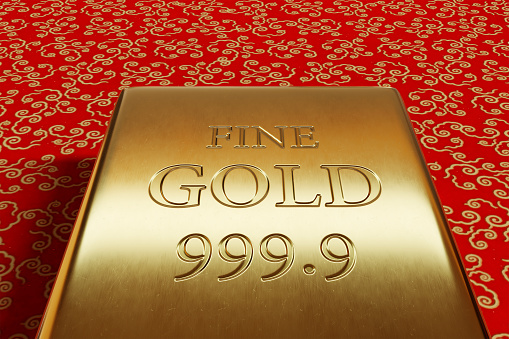 Pure gold bullion on red background with golden cloud-like patterns. Illustration of the concept of wealth, precious metal commodity and investment