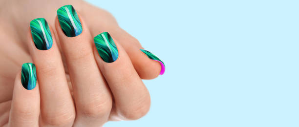 istock Female hands with green nail design 1459150734