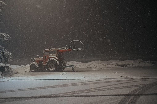 Snowplow plowing the highway during snow storm.