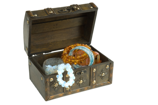Isolated oriental wooden box with jewelry on a white background