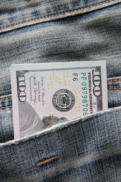 istock Dollar bills in a back pocket of jeans. 1459151863