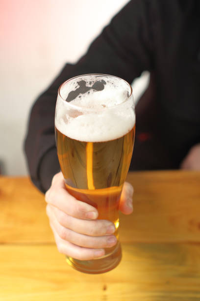 istock mug with beer in hand on the table 1459152810