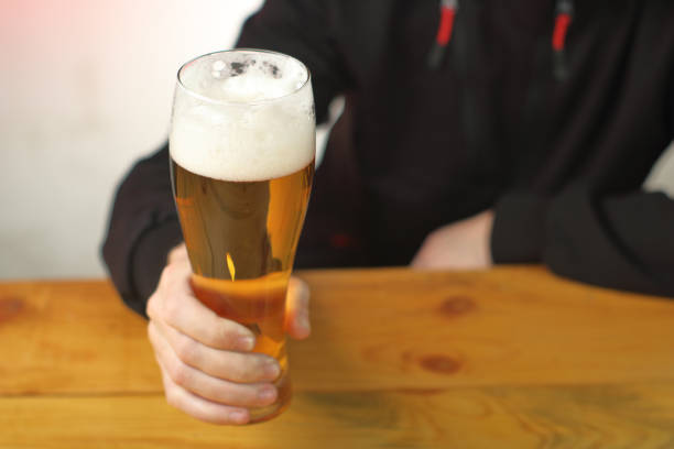 istock mug with beer in hand on the table 1459152830