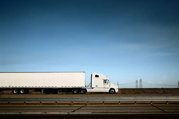 White truck on the road under blue sky