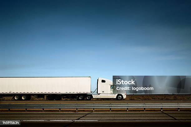 White Truck On The Road Under Blue Sky Stock Photo - Download Image Now - Side View, Truck, Semi-Truck