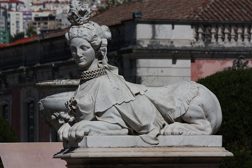 white sculpture of a lioness with a female head, Portugal