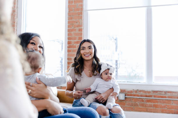 istock Two young moms smile at unrecognizable woman 1459157319