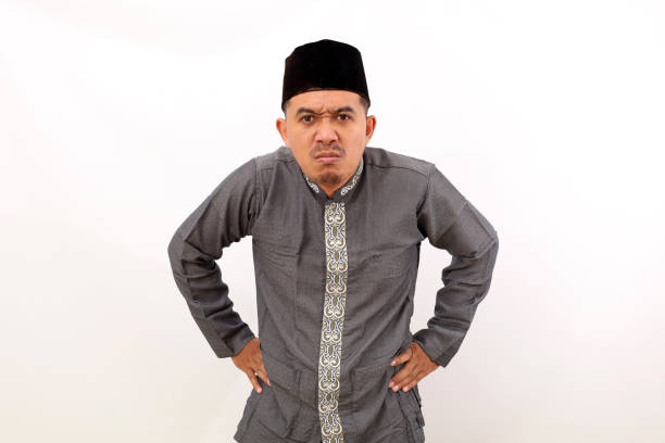 istock Angry asian muslim man standing against white background 1459158249