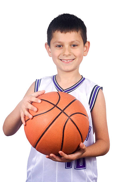 sorrindo jovem garoto segurando o basquete - basketball child dribbling basketball player - fotografias e filmes do acervo