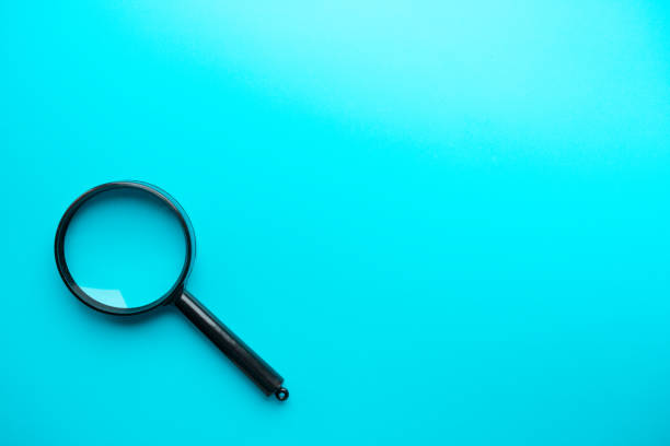 istock Magnifying glass on blue background. Top view. Flat lay. Copy space. 1459160939