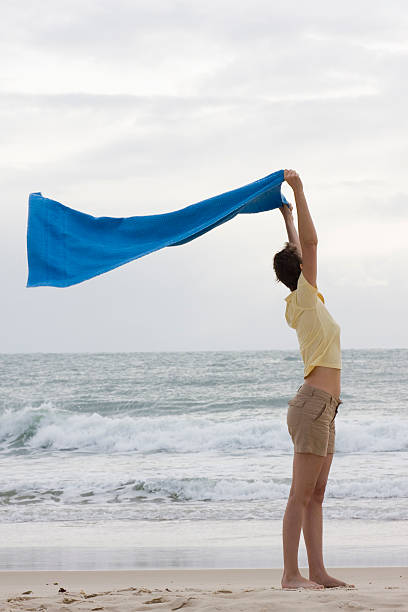 istock Woman with towel on beach 145916112