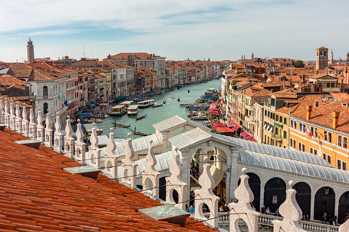 Venice, Italy - October 9th 2022:  Arch bridge made of marble over a narrow canal in the center of the old and famous Italian city Venice