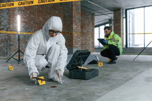 At daytime. Detectives are collecting evidence in a crime scene near dead body stock photo