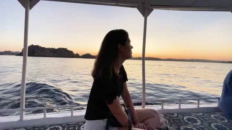 Contemplative mid adult woman in a boat in Nile River, Egypt