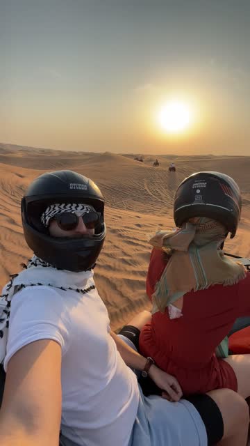 Couple riding a motorcycle in the desert