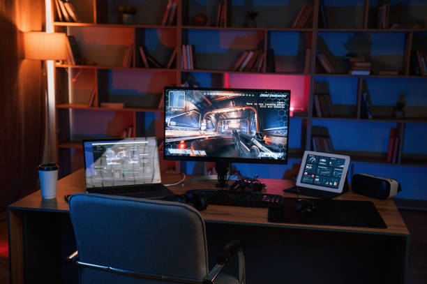 istock Computer with online first person shooter game launched. In dark room with neon lighting 1459166497