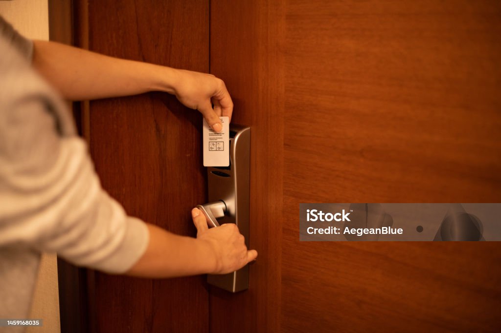 Woman Opening a Hotel Room Door with a Key Card Hotel Stock Photo